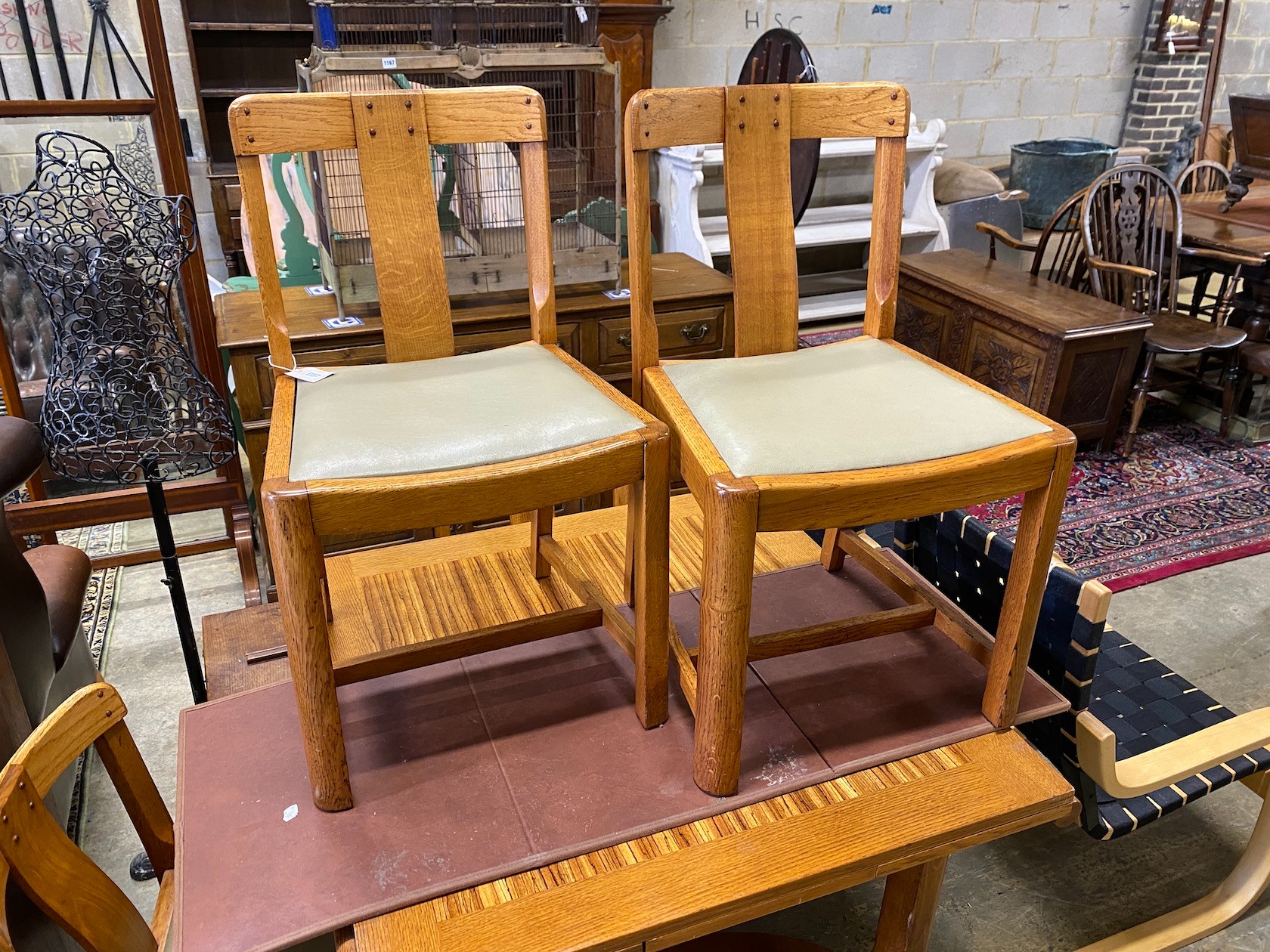An early 20th century oak and zebra wood dining suite by Ebenezer Gomme, comprising draw leaf table, four chairs and sideboard